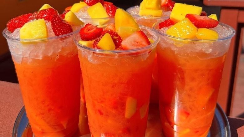A tray of strawberry aguas frescas topped with fruit