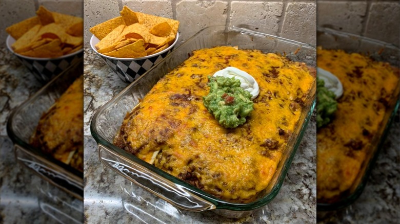 Mexican casserole topped with guacamole and sour cream