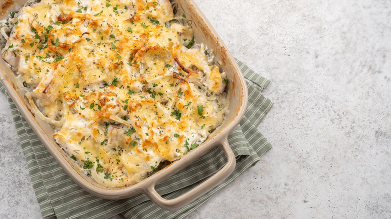 Seafood casserole in beige dish on towel