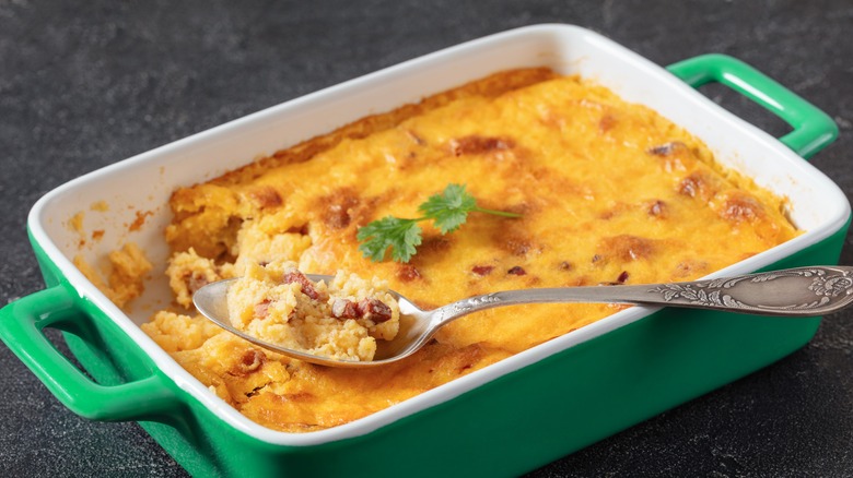 Grits casserole with sausage and spoon