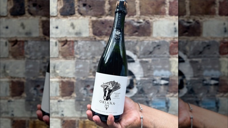 hand holding bottle of Sussex sparkling wine