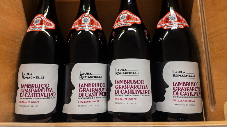 Bottles of lambrusco sparkling wine in a wooden crate