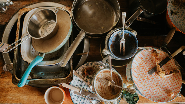 Dirty dishes stacked up on a kitchen counter
