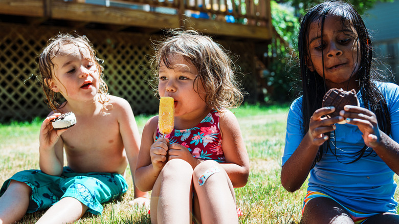 Kids eating frozen treats after swimming during the summer