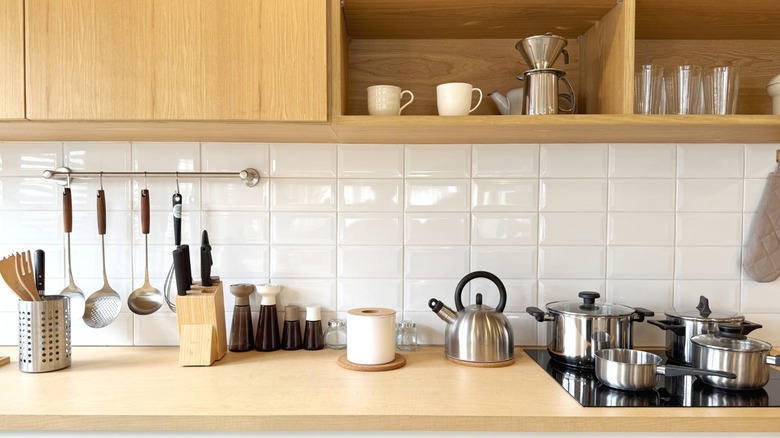 A modern kitchen with appliances and utensils.