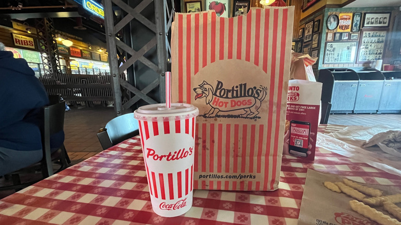 Portillo's bag and soda on a table inside the restaurant