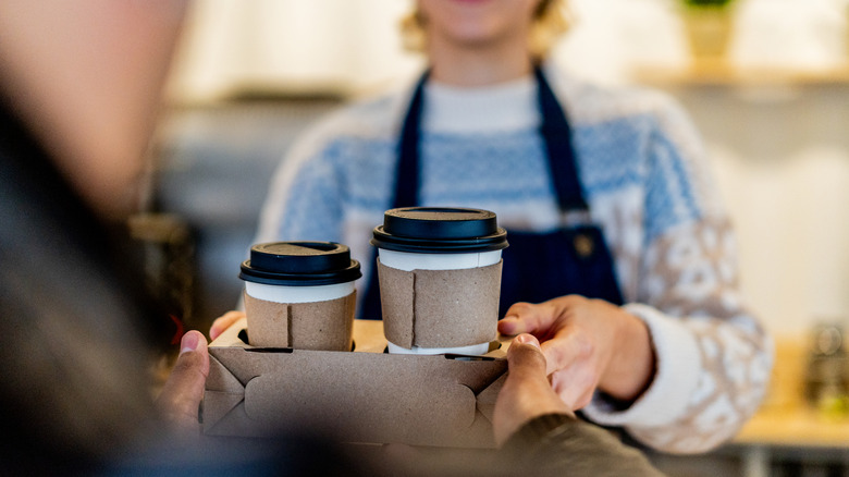 Close-up of waitress serving a customer's order at a coffee shop