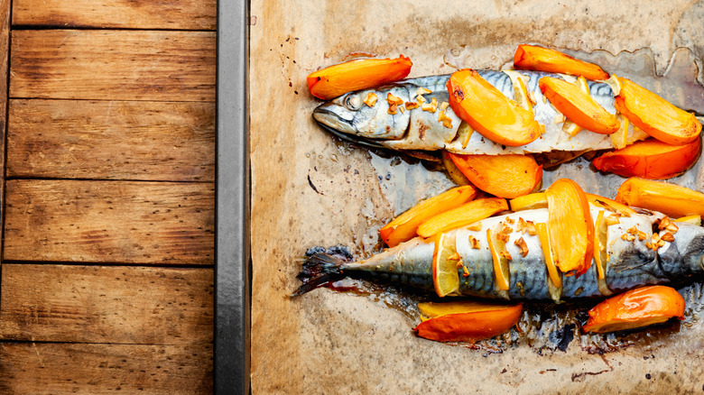 Cooked fish and persimmon on a tray