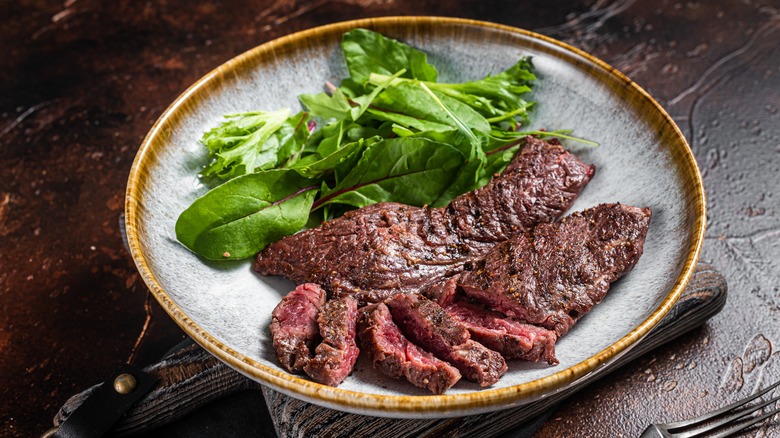 Flap steak on plate with salad