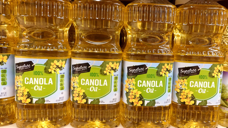 Bottles of canola oil on store shelf