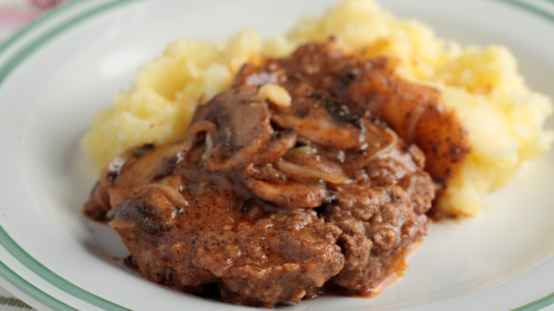 Salisbury steak with potatoes on plate