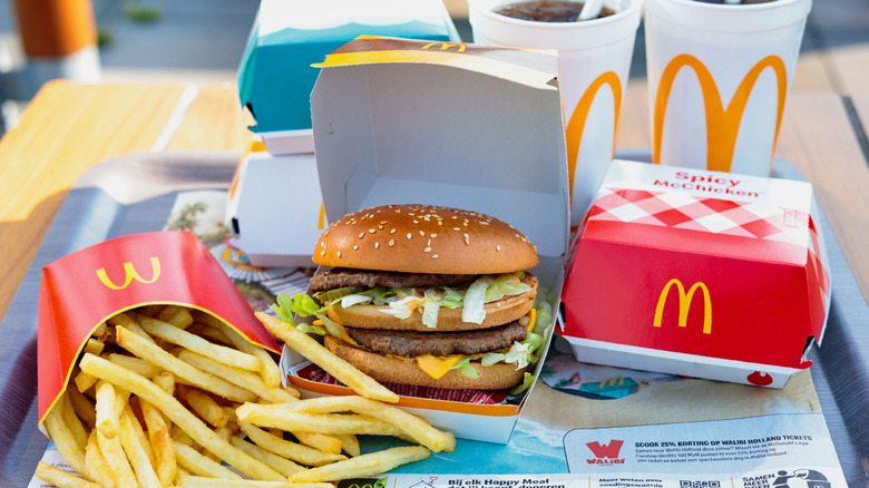 A McDonald's burger, fries, and drinks on a tray