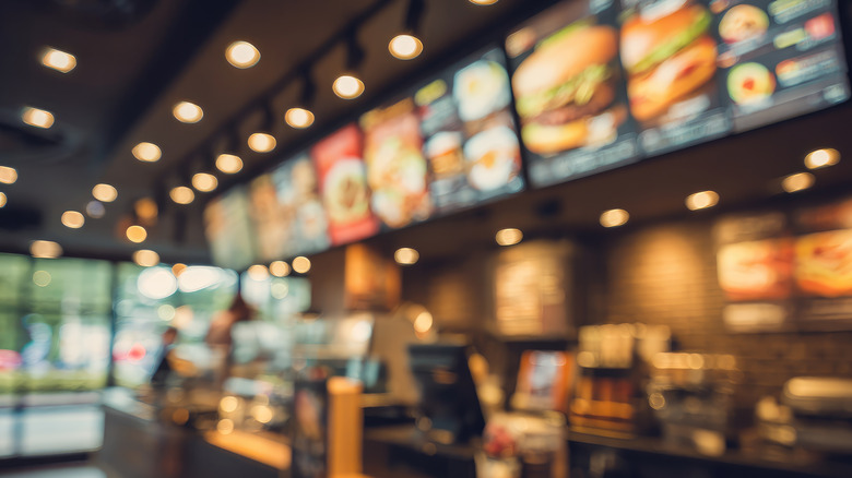 A blurred image of the interior of a typical fast food restaurant