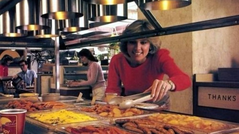A woman in the 1980s serving herself at a Roy Rogers buffet