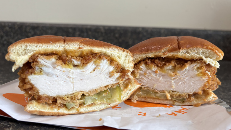 Popeyes Spicy Chicken Sandwich cut in half on wrapper