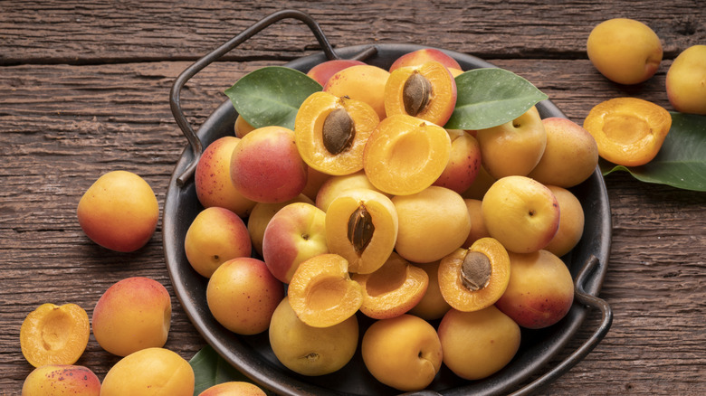 Top view of Apricot fruit with leaf on black background,