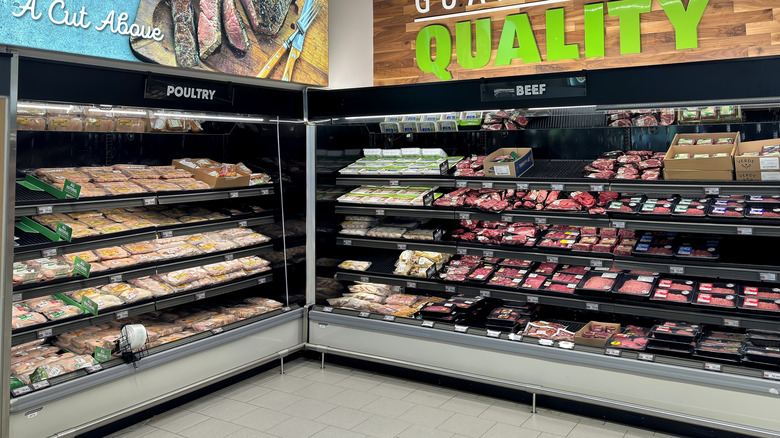 The meat section at an Aldi supermarket with quality guarantee signs