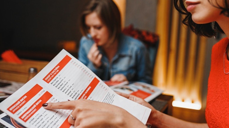 A person perusing a menu.