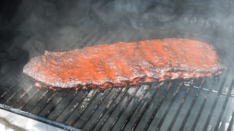rack of pork ribs on a smoker