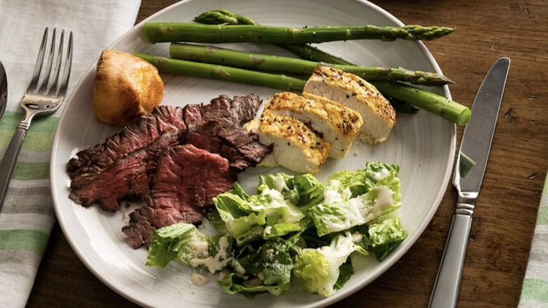 A plate of steak, chicken, and fresh vegetables from Fogo de Chao