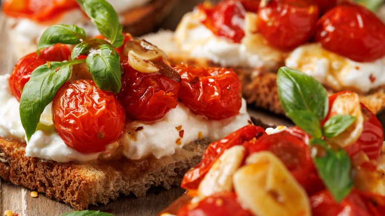Roasted tomatoes with cottage cheese, garlic, basil on bread