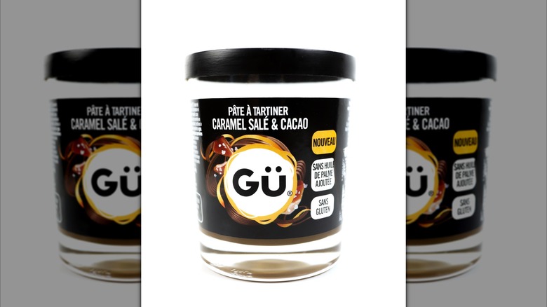 A container of Gü pudding on a white background