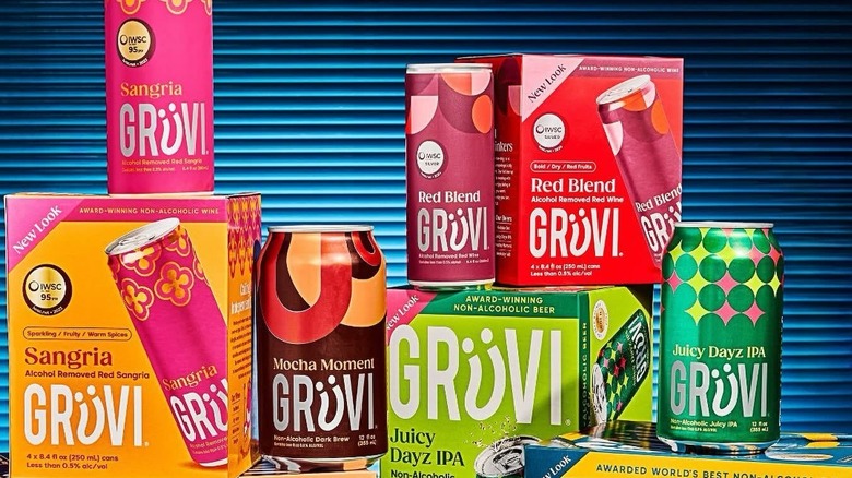 Grüvi products stacked on top of each other with a black and blue striped background.