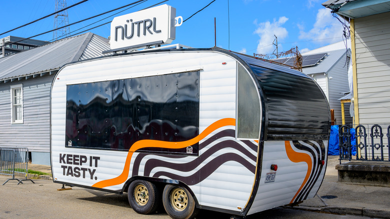 NÜTRL camper sitting on the side of the road.