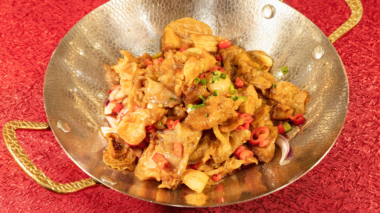 Stir-fried chitterlings, also known as chitlins, in a small wok