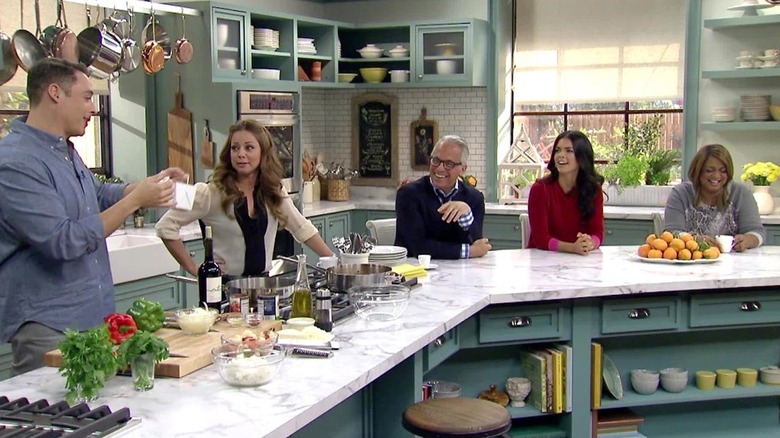 A scene from The Kitchen, with co-hosts gathered around a counter.