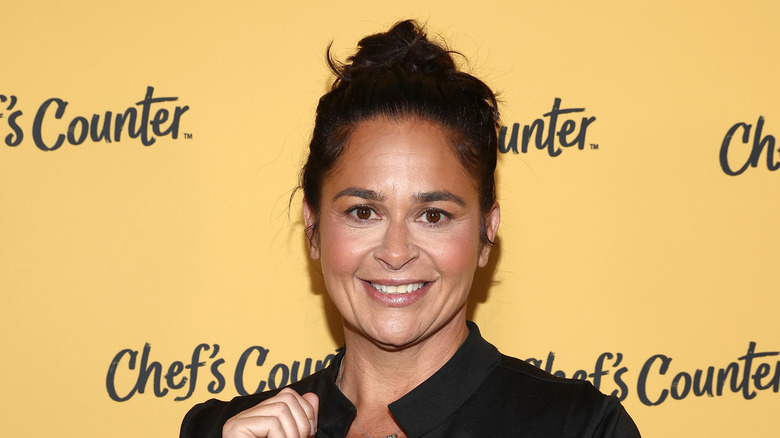Antonia Lofaso smiling against yellow backdrop