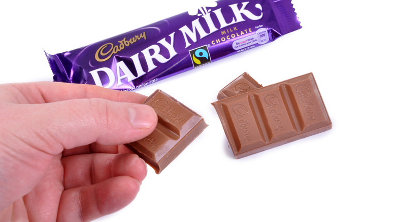 Hand holding Cadbury chocolate bar