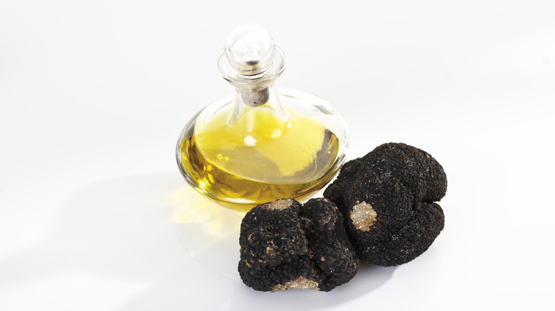 Truffle oil next to truffle mushrooms