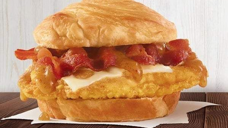 Wendy's Maple Bacon Chicken Croissant on napkin on wooden table