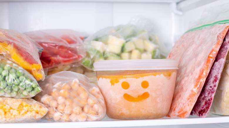 Frozen foods in bags and a container in a freezer