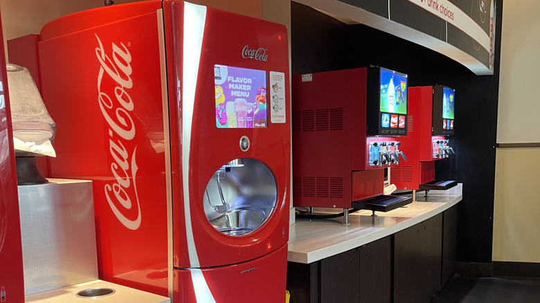 A Coca-Cola Freestyle Machine next to two Icee machines