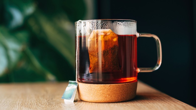 Mug of tea with tea bag on table