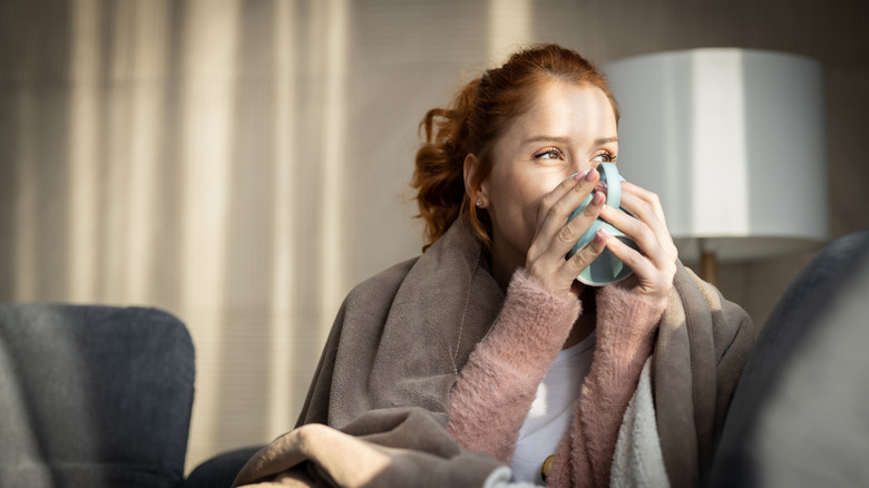 A person drinking from a mug.