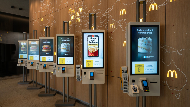 A row of six digital kiosks inside of a McDonald's location in Chicago