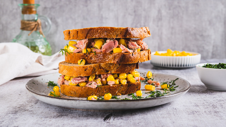 two sandwiches with tuna and corn on a plate