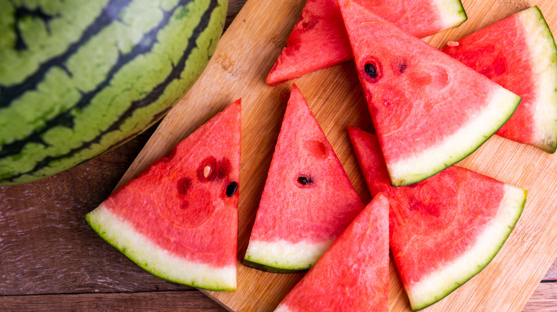 Triangles of sliced watermelon on wooden cutting board