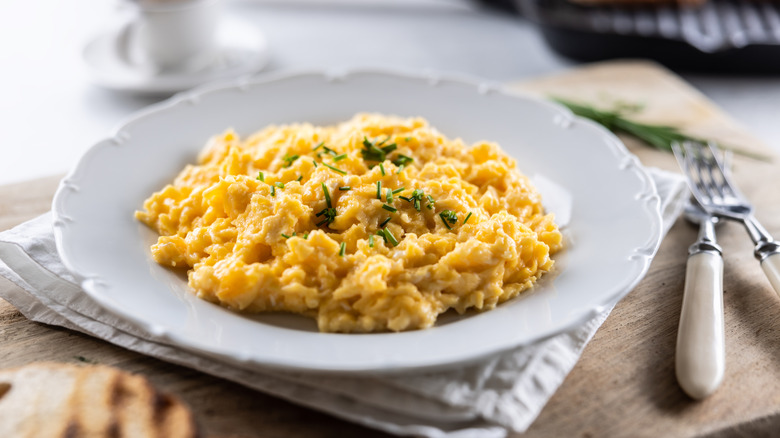 Appetizing breakfast full of proteins in the form of scrambled eggs in a plate.