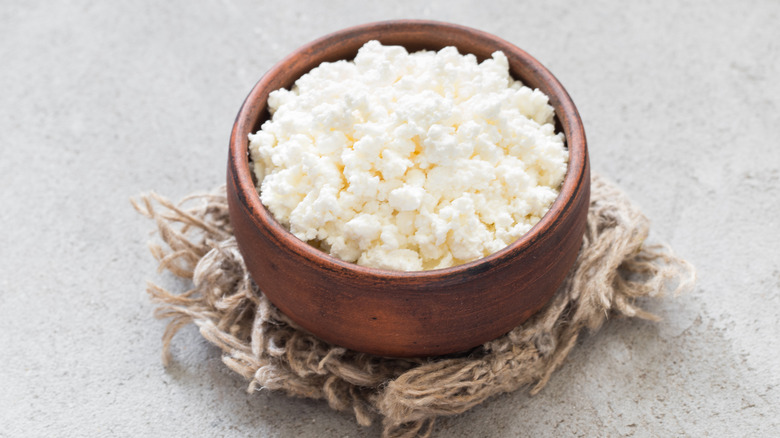 Fresh cottage cheese in a brown bowl
