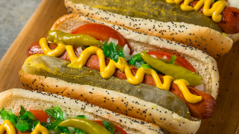 Chicago-style hot dogs on a cutting board