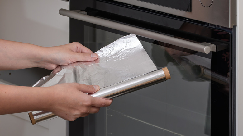 Person holding aluminum foil