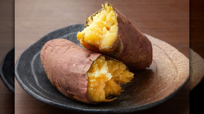 roast sweet potato halves on a black and brown plate