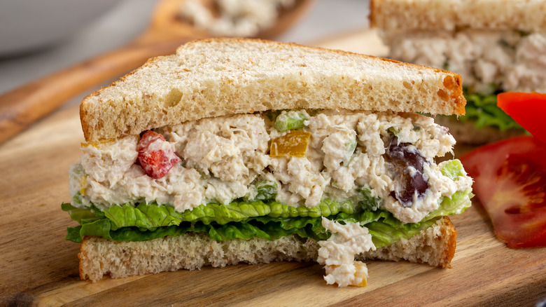 Halved chicken salad sandwich on wheat bread