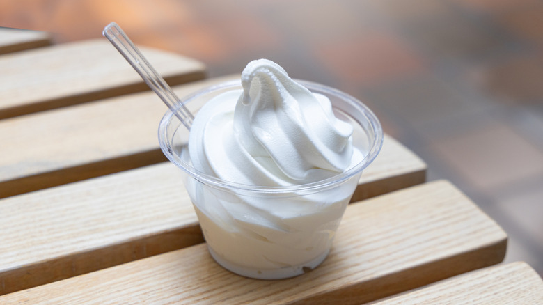 vanilla ice cream in a clear cup with a spoon