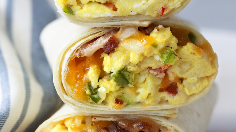 Three breakfast burritos layered on top of each other