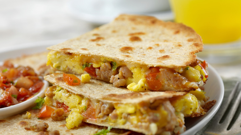 Cheesy breakfast burrito with eggs, sausage, and peppers
